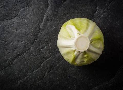 Cabbage on a black stone background. Stock Photos
