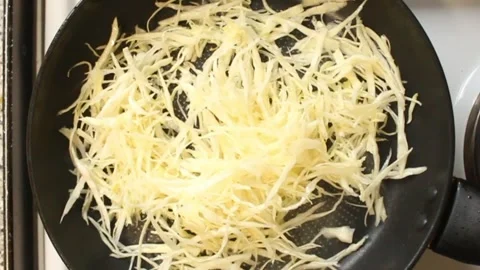 Cabbage cut into long pieces, placed in a pan. Stock Footage 303934657