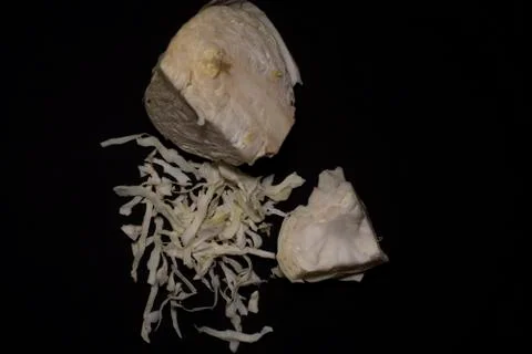 Cabbage cut in shredded form kept in a dark copy space background. Stock Photos