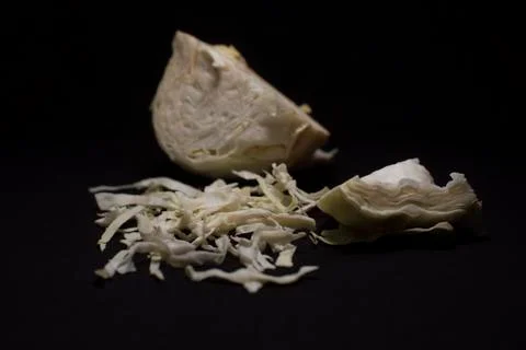 Cabbage cut in shredded form kept in a dark copy space background. Stock Photos