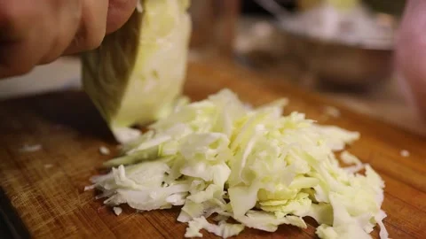 Cabbage cutting or chopping on cutting board at domestic kitchen. close up. slow Stock Footage 149437771