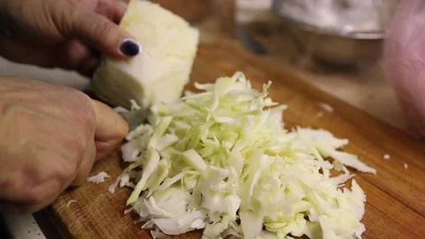 Cabbage cutting or chopping on cutting board at domestic kitchen. close up. slow Stock Footage 149437777