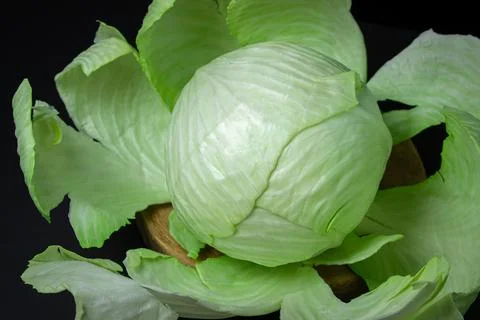 Cabbage on a dark background. Head of fresh cabbage on a black background Stock Photos