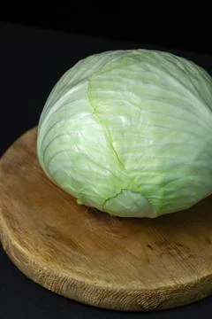 Cabbage on a dark background. Head of fresh cabbage on a black background Stock Photos