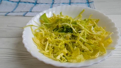 Cabbage drop t in a plate slow-motion shot Stock Footage 89765622