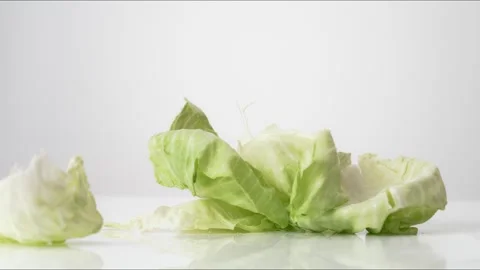 Cabbage Leaves Bouncing Slow Motion White Tabletop Closeup Macro Food Studio Stock Footage 335003885