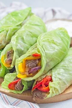 Cabbage leaves wraps with beef, vegetables and cheese, served with plain yogurt Foto stock