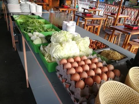 Cabbage, morning glory, celery, vegetable ,noodle, eggs and meal in buffet line  Stock Photos