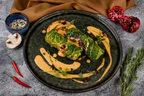 Cabbage rolls in a salad leaf with herbs and sauce Stock Photos