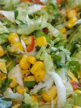 Cabbage salad with corn and various greens. Fresh healthy salad close-up Stock Photos