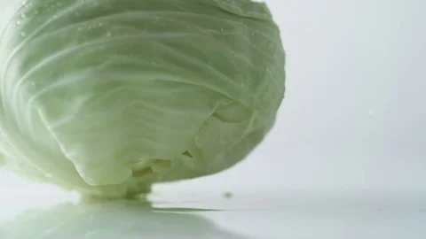 Cabbage spinning on water surface. Slow Motion. Stock Footage 79511312