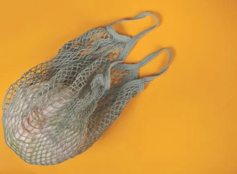 Cabbage in a string shopping bag on the yellow background. Eco shopping produ Fotos Stock