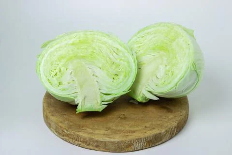 Cabbage on a white background. Cabbage cut in half on a light background Stock Photos