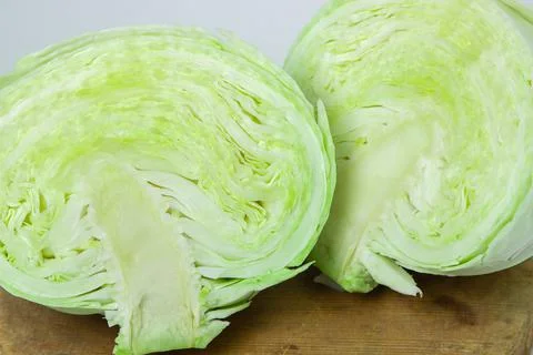 Cabbage on a white background. Cabbage cut in half on a light background Stock Photos