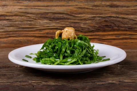 Cabbage on a white plate on a table Stock Photos
