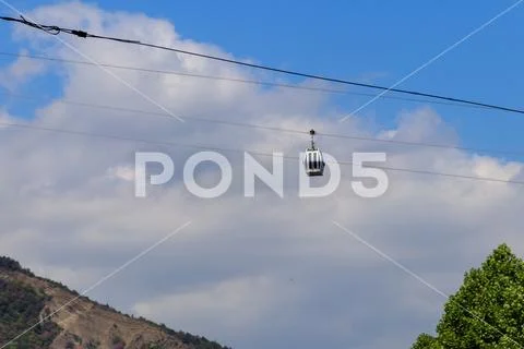Cabin of the cable car against blue sky. Cableway in Tbilisi, Georgia Stock Photos