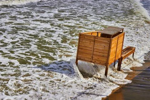 The cabin for changing is flooded with a wave during a storm Stock Photos