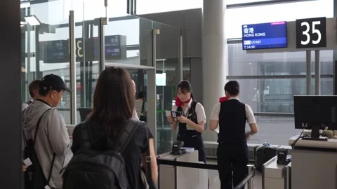 Cabin clue checking boarding pass at checking counter - 4k footage Stock Footage 245553983