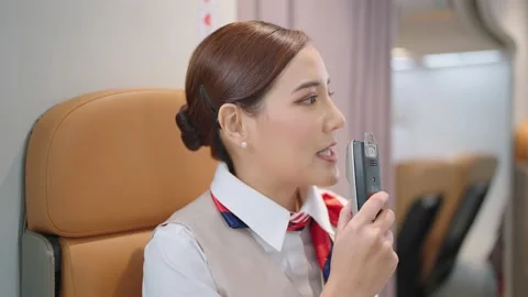 Cabin crew or air hostess flight attendants are announcing information Stock Footage 176280562