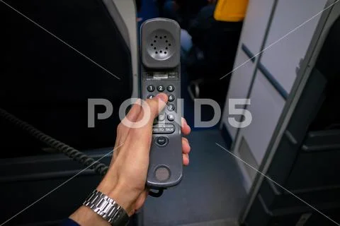 Cabin crew using interphone on first person view Stock Photos