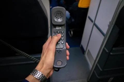 Cabin crew using interphone on first person view Stockfoto's