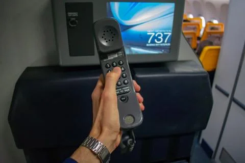 Cabin crew using interphone on first person view Stockfoto's