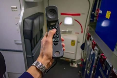 Cabin crew using interphone on first person view Stockfoto's