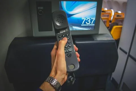 Cabin crew using interphone on first person view Stockfoto's