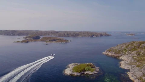 Cabin cruiser steering through islets Stock Footage 79478549