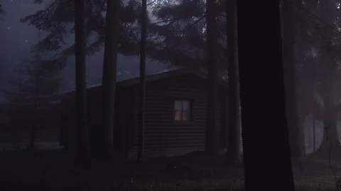 Cabin in dark misty woods. Tall pines throwing shadows on wooden cabin in the Stock Footage