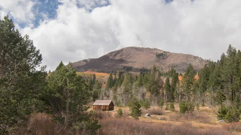 Cabin with fall colors in the mountains, 4k timelapse of clouds before storm Stock Footage 221360910