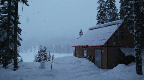 A cabin in the forest with falling snow Stock Footage 1085157