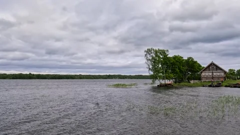 A cabin by a lake with storm clouds. Stock Footage 341791182