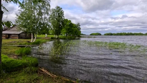 A cabin by a lake with storm clouds. Stock Footage 342387650