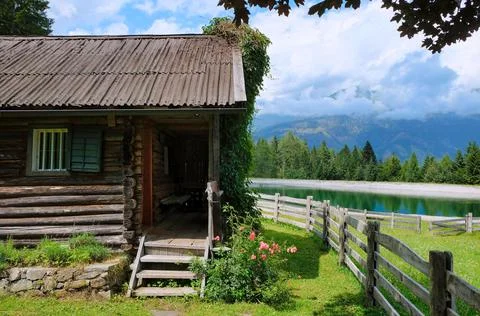 Cabin in the mountains next to a lake in the austrian alps Stock Photos