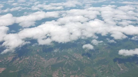 Cabin view: scattered clouds and green vegetation below. Stock Footage 335737633