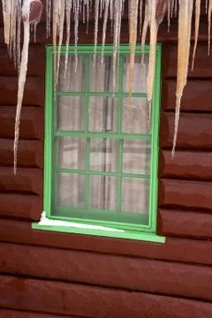Cabin window with icicles Stock Photos