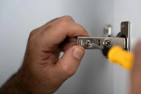 Cabinet Hinge Adjustment with Tools Stock Photos
