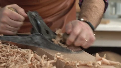 Cabinet-Maker Planes Solid Wood in his Workshop Stock Footage 75140587
