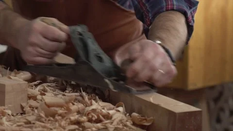 Cabinet Maker Planes Solid Wood in his Workshop Stock Footage 75142216
