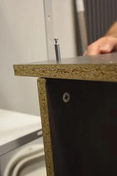 Cabinet Panel with Cam Lock Fasteners and Cam Pin Installation 库存照片