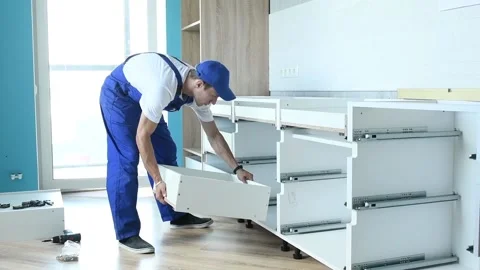 Cabinet shelf installation. Worker assembling furniture 動画素材 131396879