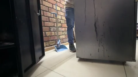 Cabinet on wheels being rolled across floor, moving furniture on warehouse or Stock Footage 337110460