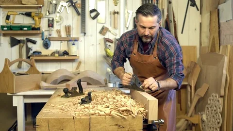 Cabinetmaker Planes Solid Wood in his Workshop Stock Footage 84909205