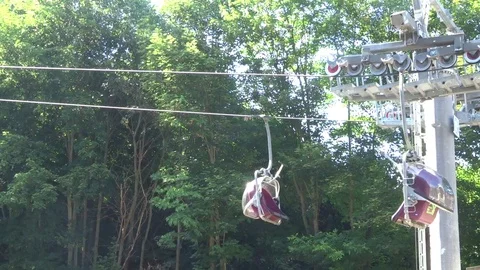 Cabins of the cableway in the background of the forest Stock Footage 104815878
