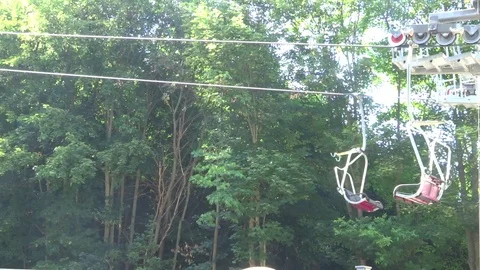 Cabins of the cableway in the background of the forest Stock Footage 104815978