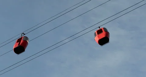Cabins of cableway with red colour and blue sky Stock Footage 108724181