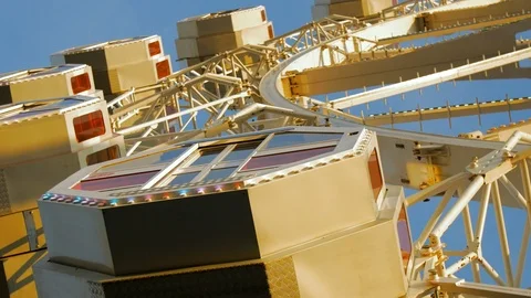Cabins from a Ferris Wheel Carousel and Blue Sky Stock Footage 88454559