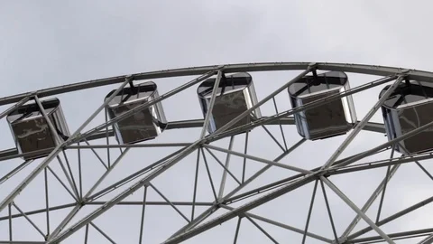 Cabins Ferris Wheel rotating on a cloudy sky background. Stock Footage 88922623
