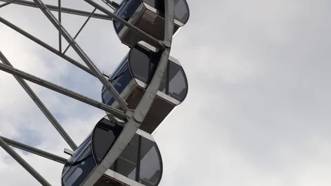 Cabins Ferris Wheel rotating on a cloudy sky background. Stock Footage 88923028